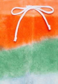 Cotton towel in orange, green, and aqua tie-dye pattern with white drawstring. Soft texture with a gradient effect.