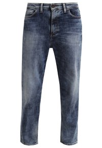 Blå blekta denimjeans med knapp- och dragkedjestängning, framfickor och subtila slitna detaljer på benen.
