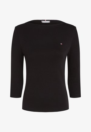 Black long-sleeve shirt made of soft cotton, featuring a wide neckline and a small logo in red, white, and blue on the left chest.