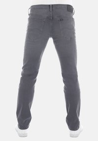 Grijze denim jeans met een slim fit, voorzien van twee achterzakken, subtiele stiksel en een leren tailleband patch. Tapered leg ontwerp.