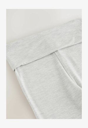 Helle graue Leggings aus weichem, dehnbarem Stoff, mit breitem umschlagbarem Bund und einer glatten Textur ohne sichtbare Nähte.
