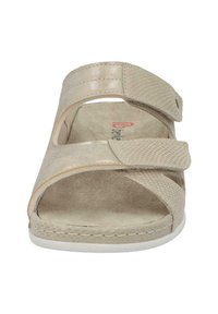 Beige sandal with open-toe design, two adjustable straps, textured surface, and a cushioned insole; white outsole.