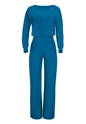 Blauer, langärmeliger Overall mit lockerer Passform, ausgestattet mit weit geschnittenen Hosenbeinen und seitlichen Taschen. Hergestellt aus weichem, elastischem Material.