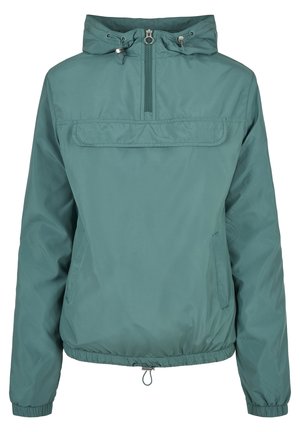 Teal windbreaker jakna s polu-zip zatvaranjem, podesivom kapuljačom i elastičnim manžetama. Ima prednji džep i regolabilni donji dio.