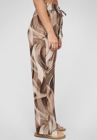 High-waisted, wide-leg pants in a brown and beige abstract pattern. Features a drawstring waist and smooth, lightweight fabric.