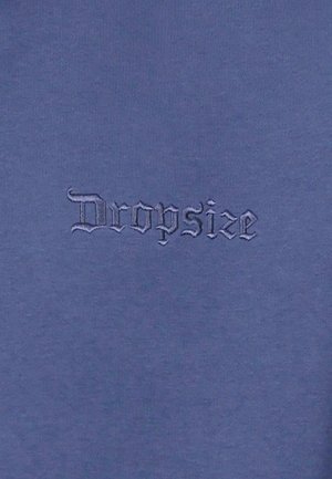 Dark blue cotton fabric featuring the word "Dropsize" in a slightly raised, stylized embroidery. Smooth texture with subtle sheen.