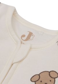Katoenen babyrompertje in crème kleur, met een teddybeerprint in bruin. Inclusief drukknoopsluiting en een zachte, gladde textuur.