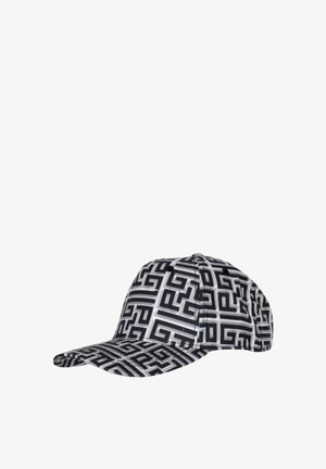 Cappellino con un motivo geometrico in bianco e nero, dotato di una visiera strutturata e design a sei pannelli, realizzato in un tessuto dalla superficie liscia.