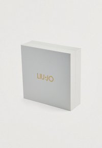 Biała pudełko prezentowe Liu Jo z teksturowaną powierzchnią i złotym logo. Kwadratowy kształt, zamknięte płaską pokrywą, z minimalistycznymi detalami.