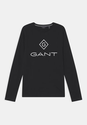 Zwart shirt met lange mouwen en ronde hals, met een wit GANT-logo en een diamantvormig embleem in het midden van de borst, getoond op een witte achtergrond.