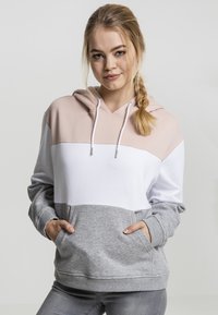 Hettegenser med fargeblokker i lys rosa, hvit og grå. Har en frontlomme og snøring på hetten. Myk tekstur.