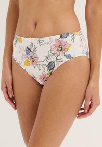 Bikini bottom floreale bianco, con fiori rosa, gialli e blu. Tessuto liscia con un delicato dettaglio di fiocco in vita.