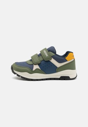 GEOX sneakers in green, navy, and cream, featuring a two-strap Velcro closure, perforated side accents, and a textured rubber sole.