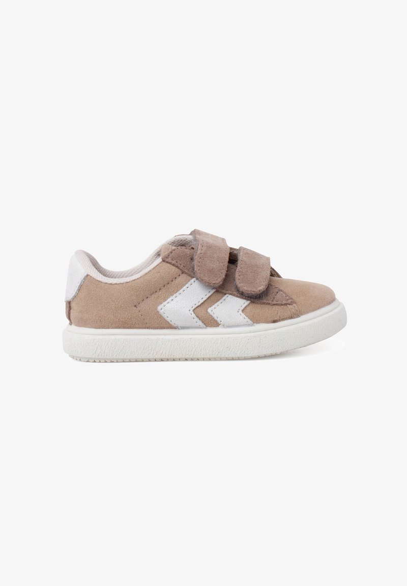 Tan suede shoes with white accents, featuring a double Velcro strap and zigzag design on the side, and a white rubber sole.