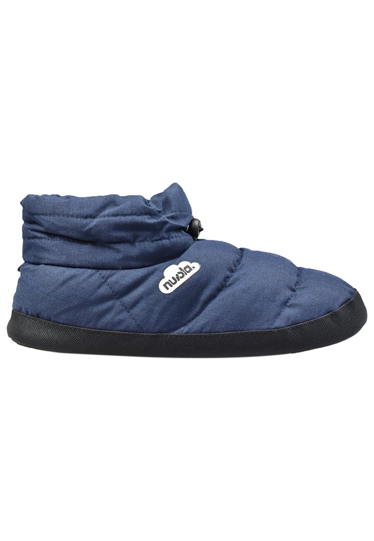 Pantuflas de color azul marino acolchadas con suela negra, que presentan un cuello fruncido y un acento con el logo en blanco. Fabricadas con un tejido suave y un diseño acolchado para mayor comodidad.