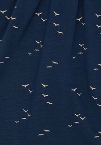 Tessuto navy con una texture morbida, caratterizzato da motivi di uccelli beige sparsi sulla superficie, creando un sottile contrasto nel design.