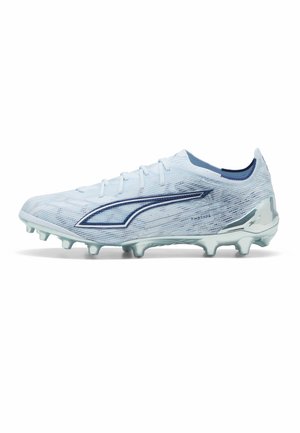 Light blue soccer cleat with dark blue logo, textured upper, molded studs, and silver heel counter for firm ground play.