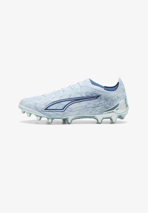 Light blue soccer cleat with dark blue logo, textured upper, molded studs, and silver heel counter for firm ground play.