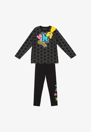Børne pyjamas s sort langærmet top med stjernemønster, der viser tegneserieansigter, bogstavet M, teksten "OOOPS!" og sorte bukser med farverige stjerner.