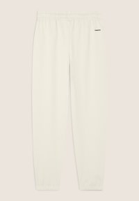 Pantaloni della tuta bianchi realizzati in tessuto morbido, con vita elastica, caviglie a costura e un piccolo logo scuro sul lato sinistro.