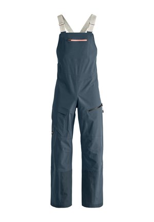 Marineblaue Latzhose aus strapazierfähigem Material, mit verstellbaren Trägern, mehreren Taschen und einer mit Reißverschluss versehenen Seitentasche für zusätzlichen Stauraum.