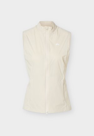 Bezrukávová béžová vesta na zips so stojatým golierom a malým bielym logom na ľavej strane hrudníka.