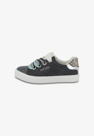 Black sneakers with white sole, patterned laces in blue and white, and glittery silver accent at heel. Brand logo on side.