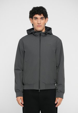 Gray hooded jacket in lightweight fabric with a front zipper, elastic cuffs, and hem. Features side pockets and a logo on the chest.