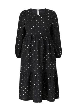 Zwarte jurk met stippen, lange mouwen, ronde halslijn, sleuteltje-detail op de rug en een gelaagde rok. Gemaakt van lichtgewicht stof met een textuur.
