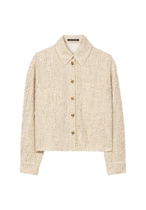 Beige strukturierte, verkürzte Jacke mit Kragen und vorderer Knopfleiste, die zwei Vorderentaschen und goldene Knöpfe aufweist.