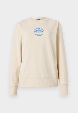 Sweat-shirt beige en coton doux, avec un col rond et des manches longues. Affiche un logo bleu dans un cadre orné au centre.