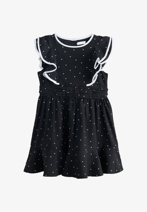 Schwarzes ärmelloses Kleid mit weißen Punkten, Rüschenbesatz an den Schultern, geraffter Taille und ausgestelltem Saum.