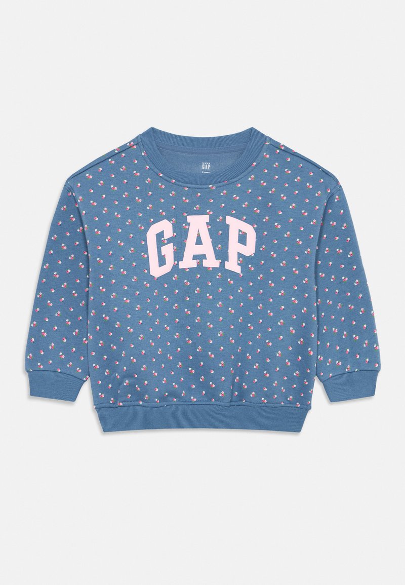 Sweatshirt azul com decote arredondado, apresentando um padrão floral repetido e um proeminente logótipo branco "GAP" em cor rosa clara.