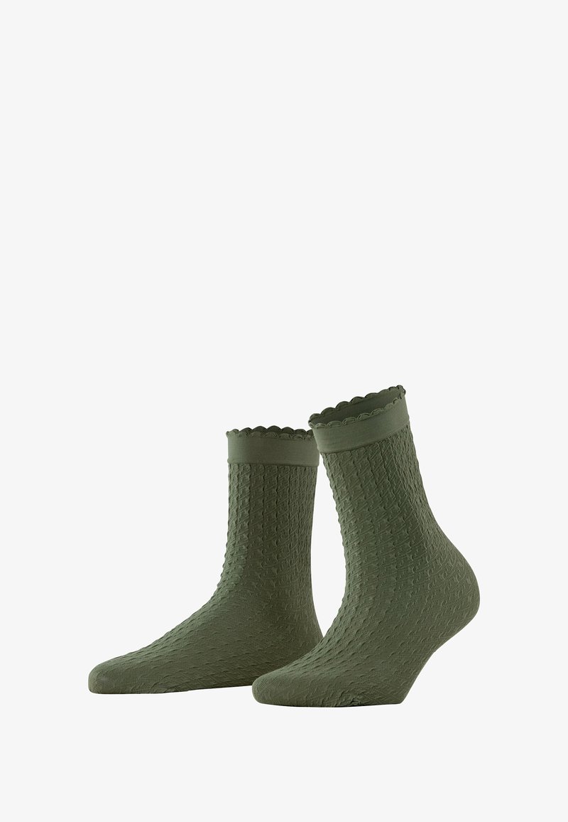 Oliwkowe skarpetki sięgające kostek z teksturowaną powierzchnią, falbankowym wykończeniem i dopasowanym kształtem. Wykonane z miękkiego materiału dla większego komfortu.