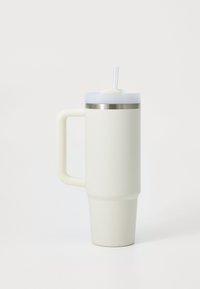 White insulated travel mug with a textured grip, a stainless steel rim, and a clear lid featuring a reusable straw.