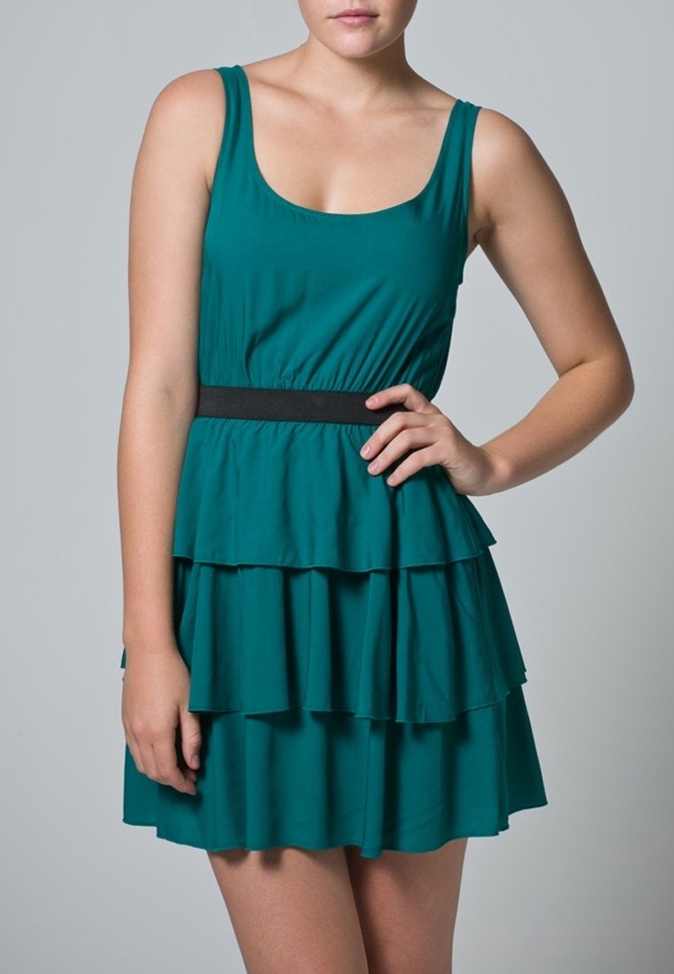 Türkisfarbenes ärmelloses Kleid mit tailliertem Oberteil und Stufenrock mit Rüschen, versehen mit einem schwarzen Taillenband, gefertigt aus leichtem Stoff.