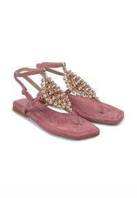 Infradito in suede rosa con un gruppo decorativo di strass trasparenti e oro rosa sulla fascia superiore. Suola piatta con dettagli di design minimal.