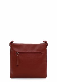 Red leather handbag with a textured surface, a top zip closure, and a front zipped pocket. Features adjustable strap and decorative tassel.