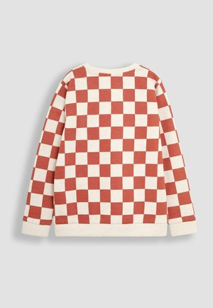 Sarkans un krēms pārbaudījumu dizains, ar apaļu kakla izgriezumu, garām piedurknēm un ribotiem aprocēm un apakšmalu, izgatavots no teksturētas kokvilnas materiāla.