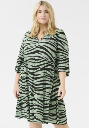 Green and black striped dress with a V-neck, 3/4 sleeves, and a tiered skirt design made of lightweight fabric.