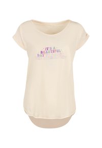 Light beige t-shirt with a loose fit. Features a round neckline and rolled short sleeves. Text in colorful letters: "It's a beautiful day to smash the patriarchy."