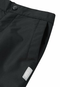 Schwarze wasserdichte Hose mit glatter Textur, ausgestattet mit einem Knopfverschluss, seitlichen Taschen und einem remoTEC-Label auf der Tasche.