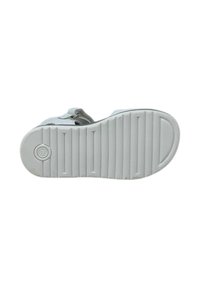 Suola di scarpa bianca con righe orizzontali, logo circolare e superficie liscia. Punta arrotondata e tallone leggermente sollevato per una maggiore aderenza.