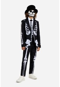 Black suit with white skeleton print, including skeletal rib and bone details; paired with a white shirt, tie, and black top hat.