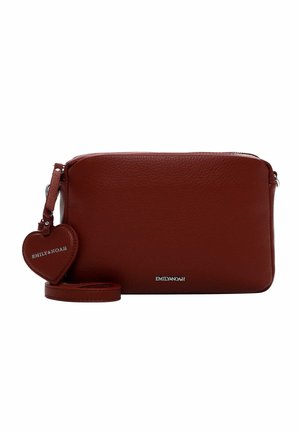 Red leather crossbody bag with a smooth texture, zip closure, and a detachable heart-shaped tag. Features a matching strap.