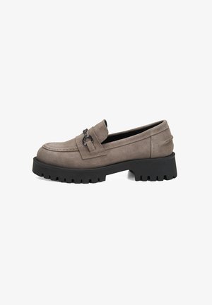 Gray suede loafer with a chunky black sole, featuring a decorative strap and metallic accent. Smooth texture with a rounded toe design.