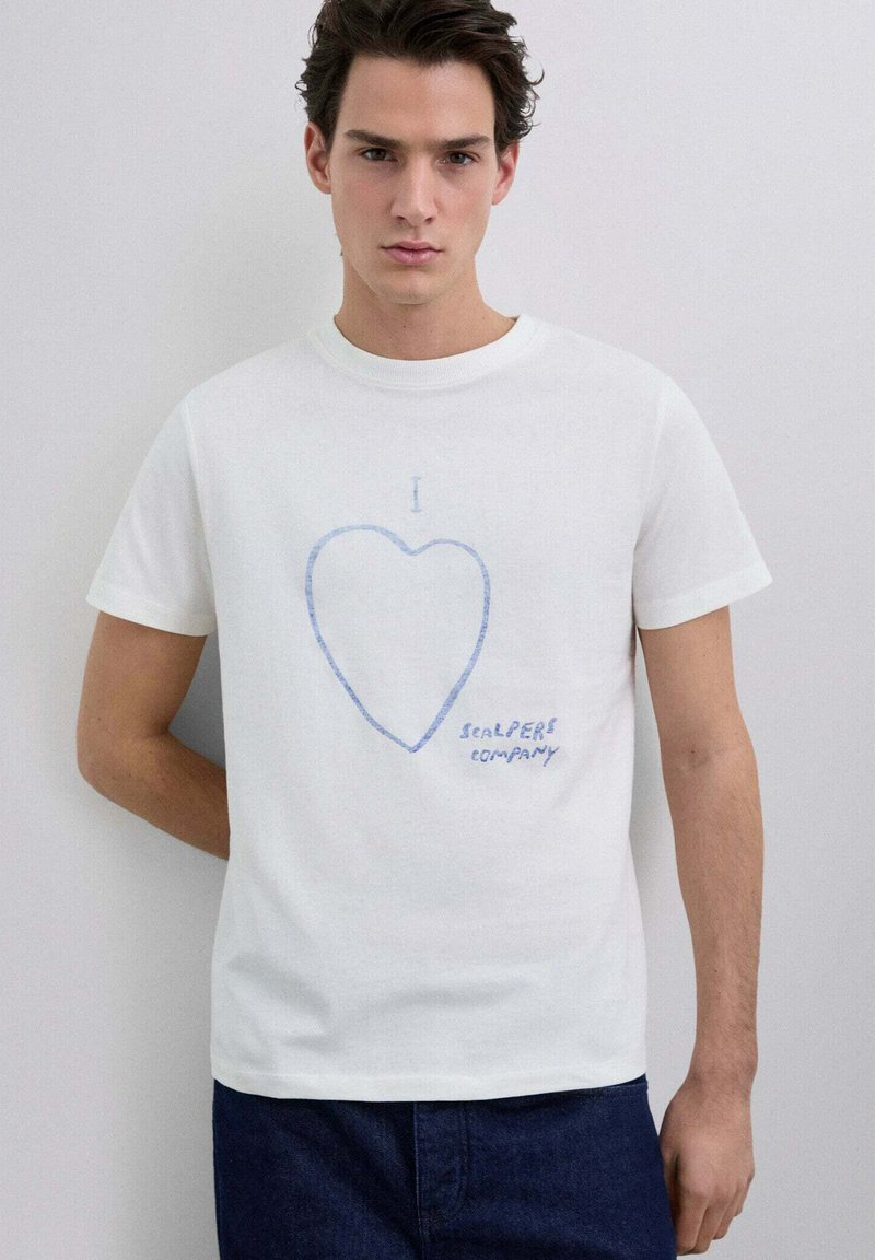 Camiseta blanca de algodón de manga corta, con un gráfico de un corazón azul y el texto "I SEALPERS company" impreso debajo.