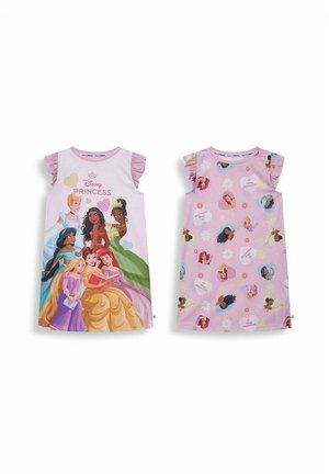 Young girl smiling, standing with arms slightly out, wearing a white dress with pink sleeves featuring Disney Princess characters.