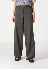 Gray pinstriped wide-leg pants, high-waisted with a smooth texture. Paired with a cropped light blue top, featuring intricate patterns.