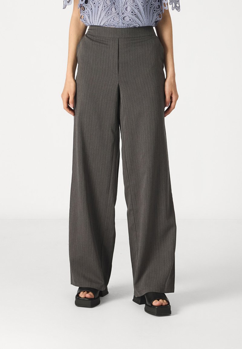 Gray pinstriped wide-leg pants, high-waisted with a smooth texture. Paired with a cropped light blue top, featuring intricate patterns.